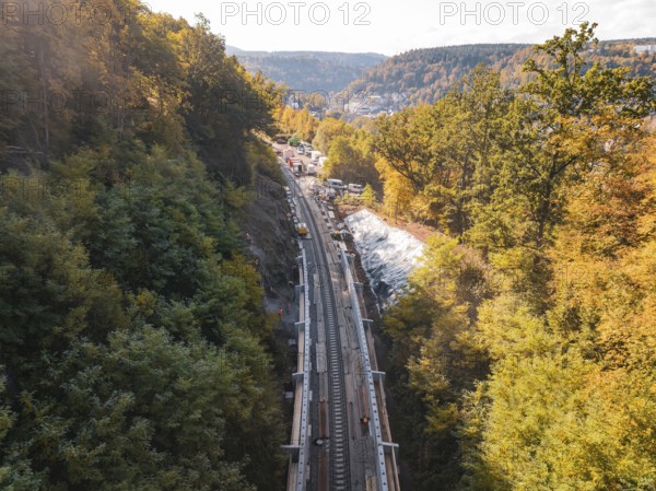 Autumn landscape with construction on railroad tracks and surrounding forest in the sun, Bau der Hermann, Hesse, Bahn, Calw, Germany