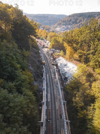 Construction work on railroad tracks in the middle of an autumn forest with excavators and hills, construction of Hermann, Hesse, Bahn, Calw, Germany