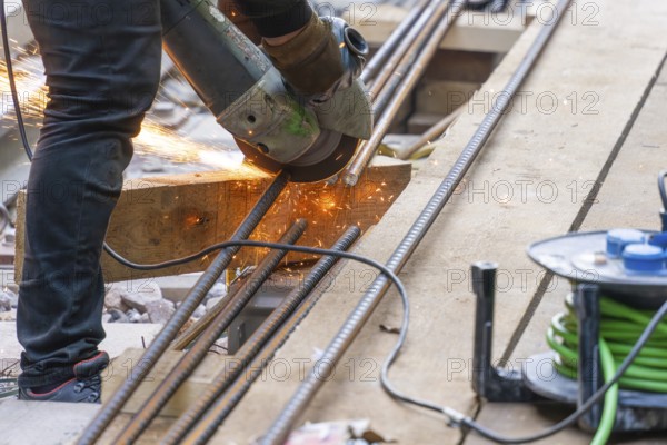 A construction worker cuts metal bars with a flex machine, Bau der Hermann, Hesse, Bahn, Calw, Germany