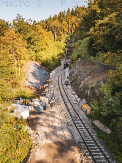 Construction site for railway track system in an autumnal, green forest under sunny skies, Bau der Hermann, Hesse, Bahn, Calw, Germany