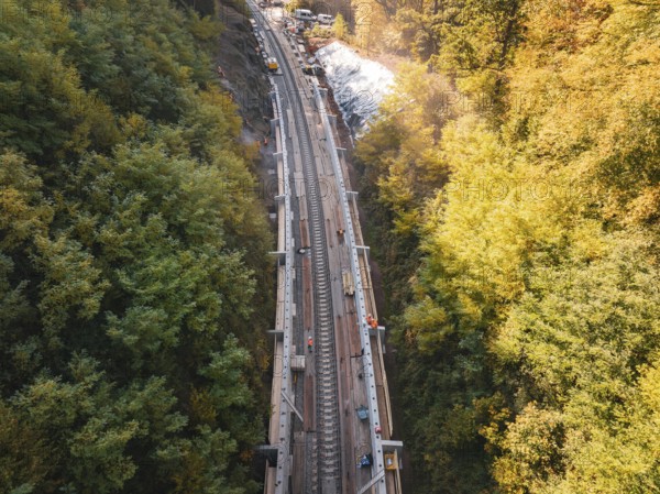Construction work on tracks in autumn forest, under bright sunshine, construction of Hermann, Hesse, railway, Calw, Germany