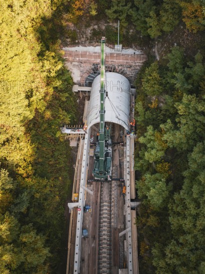A bird's eye view of crane construction during tunnel construction in an autumnal landscape, construction of Hermann, Hesse, Bahn, Calw, Germany