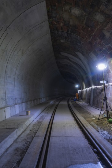 Tunnel with rails and bright lighting along the wall, dark building atmosphere, Hermann building, Hesse, railway, Calw, Germany