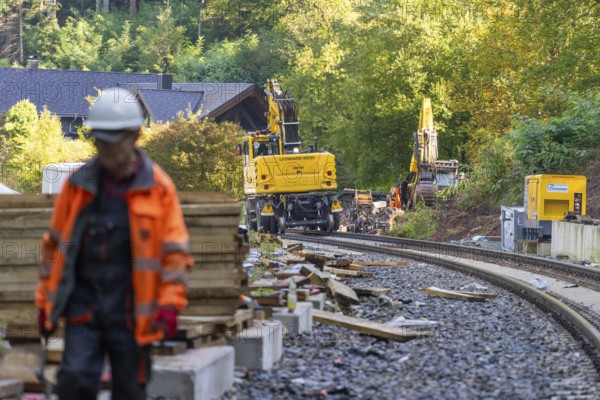 A worker on a construction site with construction machinery in the background, Bau der Hermann, Hesse, Bahn, Calw, Germany