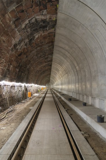 An empty tunnel with rails and lighting on a railway line, built by Hermann, Hesse, Bahn, Calw, Germany