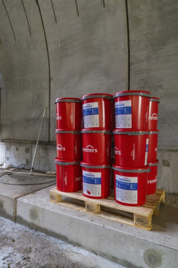 Red paint buckets on a pallet in a tunnel setting, building materials stored, building of Hermann, Hesse, Bahn, Calw, Germany