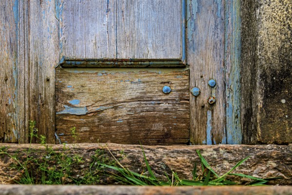Details of an old baroque church door made of wood, weathered by time, in Ouro Preto city, Ouro Preto, Minas Gerais, Brazil