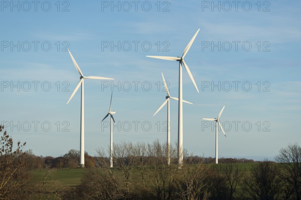 Wind turbines stand on a wide meadow under a clear blue sky, Swabian Jura, Baden-Württemberg, Germany