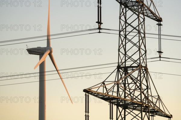 Wind turbine next to a power pole, modern energy motif, Swabian Jura, Baden-Württemberg, Germany