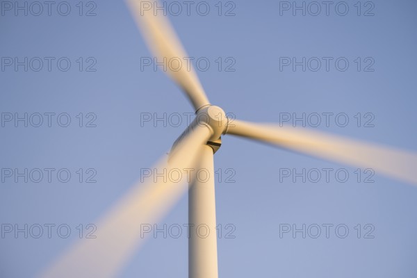 Close-up of a wind turbine in motion against a blue sky, Baden-Württemberg, Germany