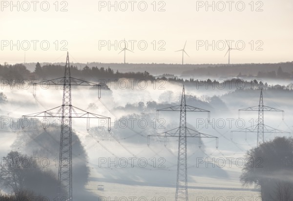 Morning atmosphere with foggy landscape and power poles in the foreground, Swabian Jura, Baden-Württemberg, Germany