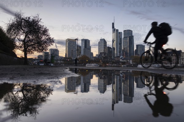Frankfurt's banking skyline is reflected in a puddle in the evening, Frankfurt am Main, Hesse, Germany