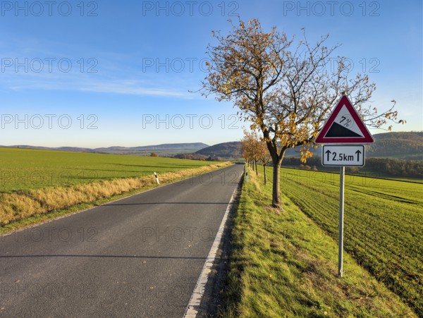 Country road through hilly, agricultural landscape, road sign warns of slopes, slopes, sunny autumn weather, Rühle, Bodenwerder, Rühler Switzerland, Vogler, Weser Hills, Lower Saxony, Germany