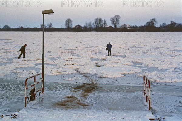People walk across ice rink, ferry dock, frozen Elbe, Bleckede, Lower Saxony, Germany, January 03, 1997, vintage, retro, old, historic
