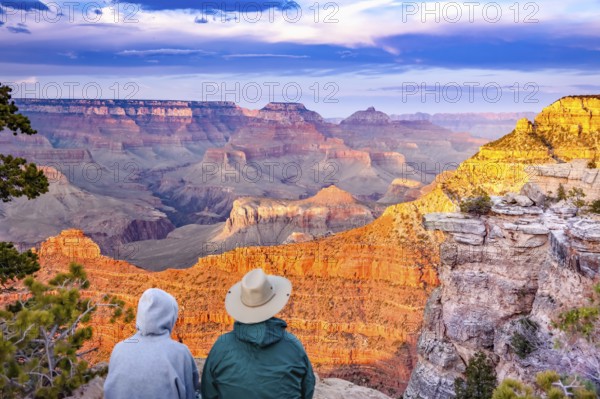 Couple enjoying the beautiful landscape of the grand canyon sunset