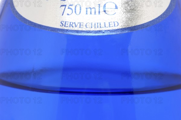 Glass with mineral water, small carbonated pearls on the edge of the glass, drinking water