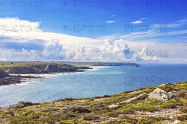 Seascape view at a seabay on a rocky coastline a sunny summer day by the sea with dramatic clouds on the blue sky, Crozon peninsula, Bretagne, France