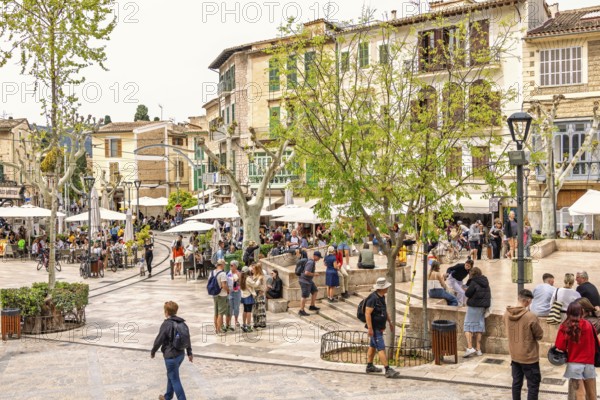 Town square in Sóller with outdoor restaurants and tourists a famous idyllic small town for tourism, Soller, Mallorca, Spain