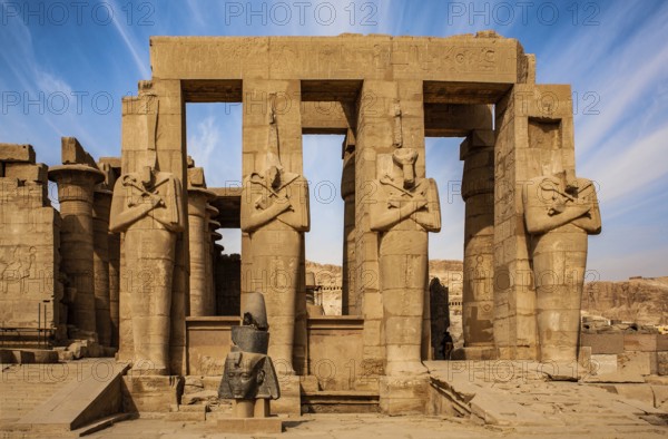 2nd courtyard with Osiris statues, head of a statue of Ramesses II in front of it, Ramesses II mortuary temple, Luxor, West Thebes, Egypt, Thebes, West