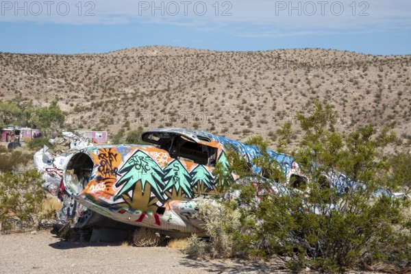 Beatty, Nevada - A decorated twin-engine airplane lies in the desert after a 1977 crash. The aircraft crashed during a promotional stunt for a brothel