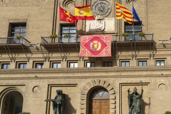 Flags flying Ayuntamiento city hall building, Plaza del Pilar, city centre of Zaragoza, Aragon, Spain