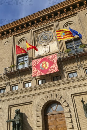 Flags flying Ayuntamiento city hall building, Plaza del Pilar, city centre of Zaragoza, Aragon, Spain