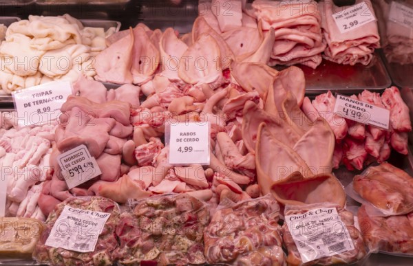 Market stall shop store selling butcher meat pork offal products inside Mercado Central de Zaragoza, Zaragoza, Aragon, Spain