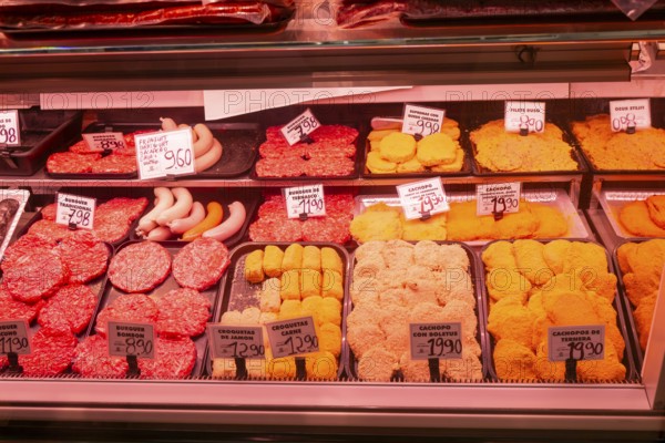 Market stall shop store selling butcher meat products inside Mercado Central de Zaragoza, Zaragoza, Aragon, Spain