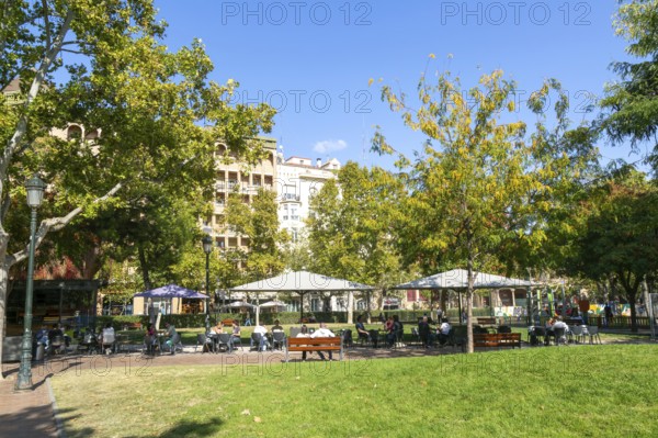 People at outdoor cafe in public park, Plaza de los Sitios de Zaragoza, Zaragoza, Aragon, Spain