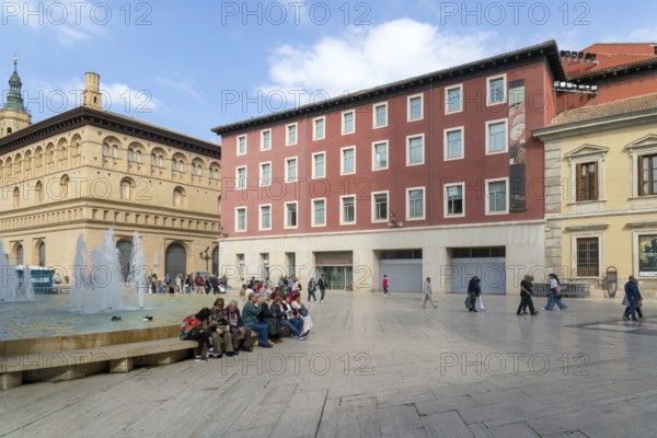 People sitting by fountain and historic buildings, Plaza la Seo, Zaragoza, Aragon, Spain