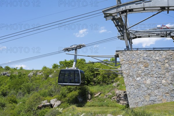 Close-up of a cable car gondola surrounded by nature and under clear skies, Tatev cable car, Wings of Tatev, cable car station, Halidzor, Syunik province, Caucasus, Armenia