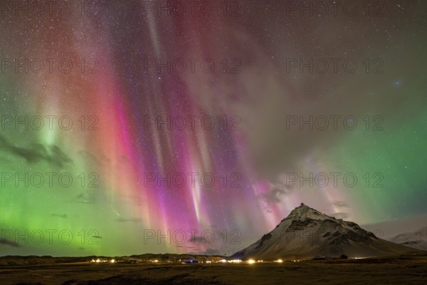 Northern lights, aurora borealis over mountain, Arnastapi, Iceland
