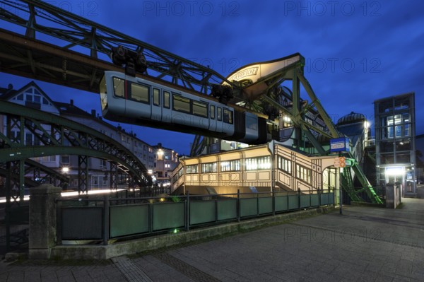 The Wuppertal suspension railway goes to the Werther Brücke stop, Wuppertal, Germany at blue hour, digitally reworked