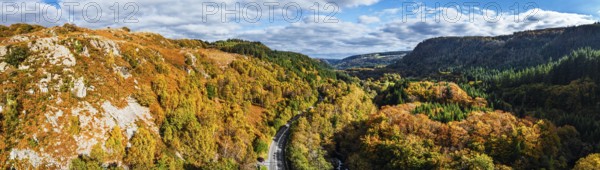Autumn colours over Gwydir Forest Park from a drone, Afon Lledr, Road A470, Snowdonia, Eryri, Wales, England, United Kingdom