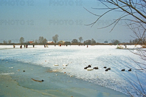 People walk across ice rink, coots, frozen Elbe, Bleckede, Lower Saxony, Germany, February 9, 1996, vintage, retro, old, historic