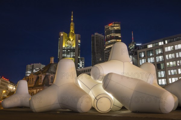 Illuminated tetrapods lie at Hauptwache in front of Frankfurt's banking skyline, Frankfurt, Hesse, Germany