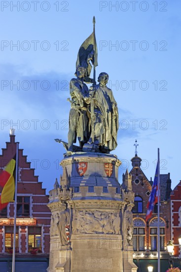 Illuminated monument to Jan Breydel and Pieter de Coninck in the evening light on the market square in the old town of Bruges, Grote Markt, UNESCO World Heritage Site, Flanders, Belgium