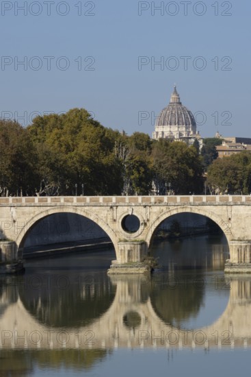 Bridge over the river Tiber with the dome of St. Peter's Basilica in the Vatican city in the background, Rome, Italy