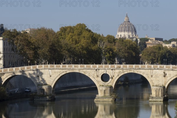 Bridge over the river Tiber with the dome of St. Peter's Basilica in the Vatican city in the background, Rome, Italy