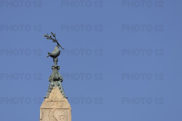 Peace dove bird sculture on the top of a building in the city of Rome, Italy