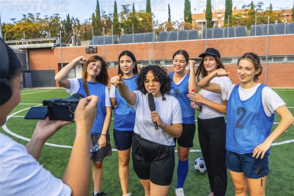 Reporter with microphone interviewing a diverse women's soccer team on a green field, capturing moments of friendship, empowerment, and sports journalism