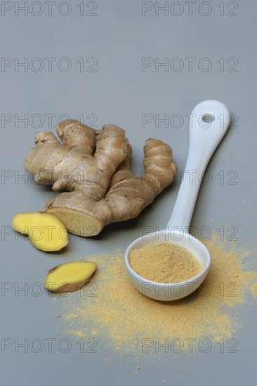 Ginger root and ginger powder in spoon, Zingiber officinale