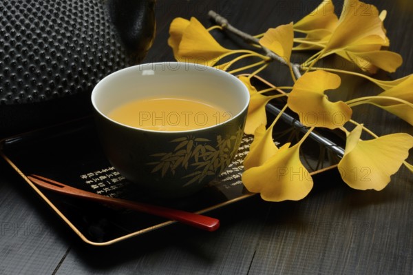 Ginkgo tea in tea bowl and ginkgo leaf, ginkgo biloba
