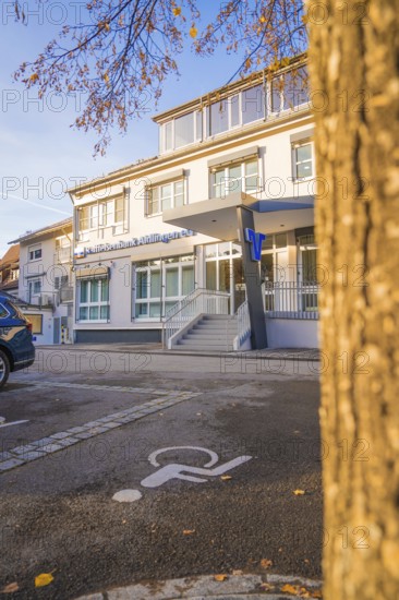 Modern building complex with parking lot and wheelchair-friendly markings, autumnal atmosphere, Aidlingen, Böblingen district, Germany