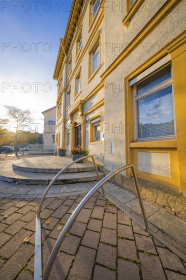 Historic building with entrance area, warm sunlight on paved courtyard, Aidlingen, Böblingen district, Germany