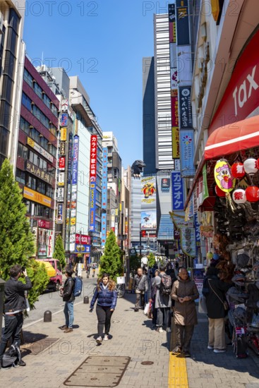 Street scene with skyscrapers, figure Godzilla head on a skyscraper, Shinjuku City, Tokyo, Japan
