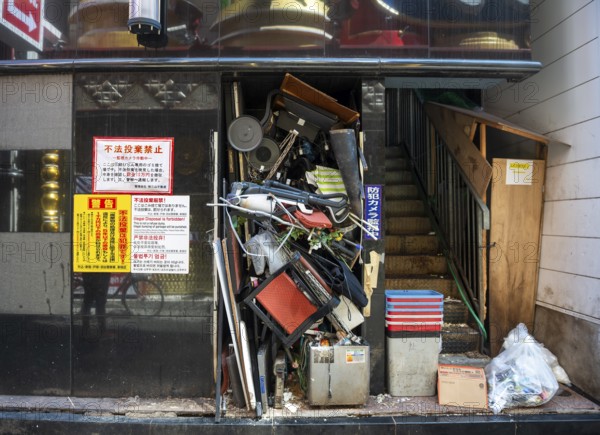 Bulky waste in a damaged house entrance, Shinjuku City, Tokyo, Japan