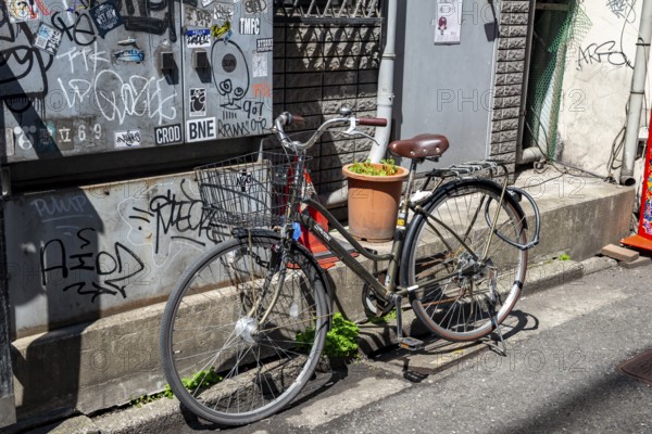 Locked bicycle on the side of the road, Shinjuku City, Tokyo, Japan