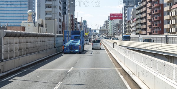 Multi-lane high street next to residential buildings, Shinjuku City, Tokyo, Japan