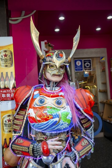 Futuristically dressed mannequin with colorful armor, cosplay, in front of a restaurant, Shinjuku City, Tokyo, Japan